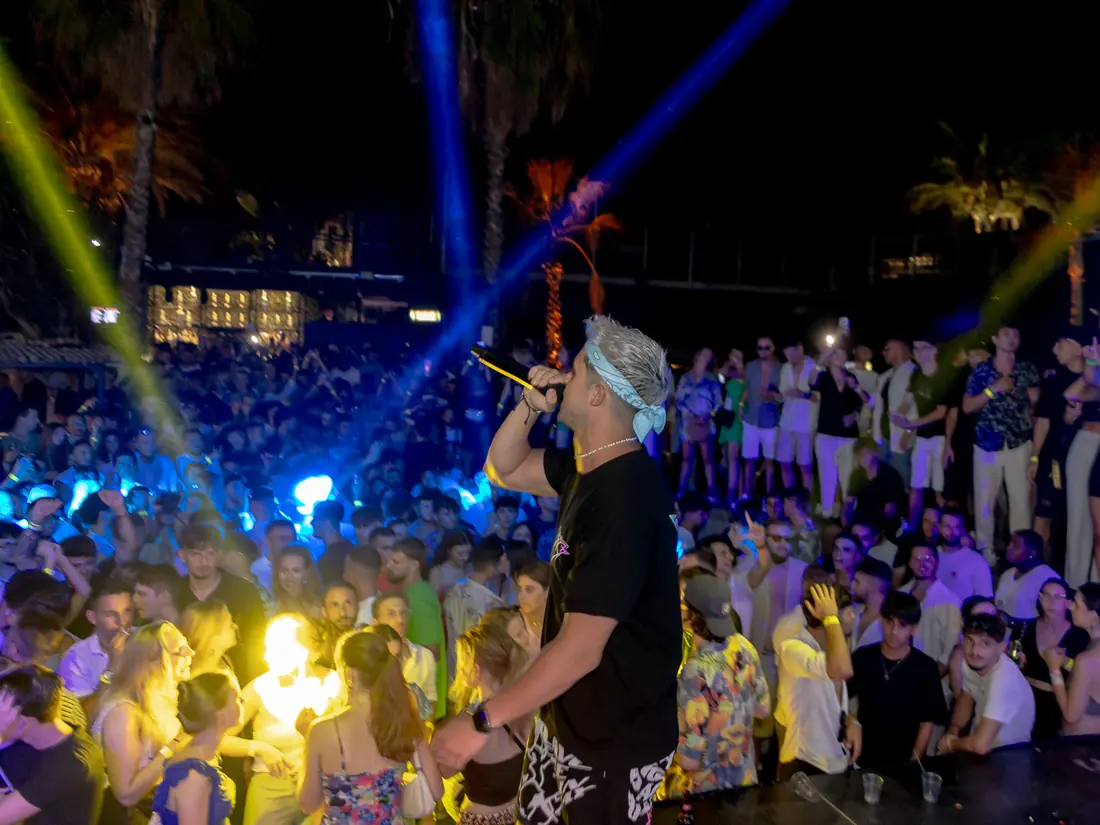 JK playing an open-air daytime party in Malta with a large crowd